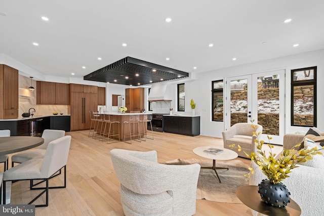 living room featuring french doors and light hardwood / wood-style floors