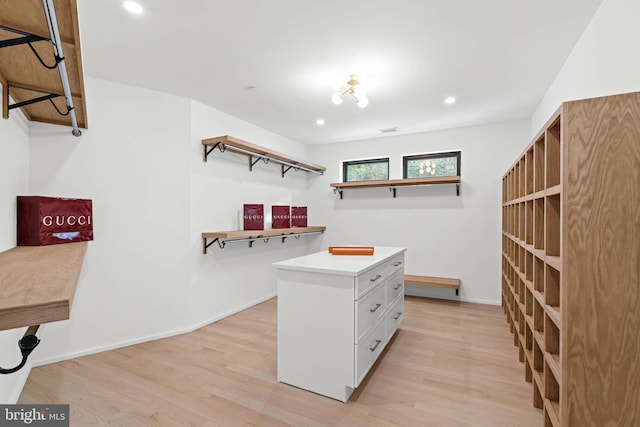 walk in closet featuring light hardwood / wood-style flooring