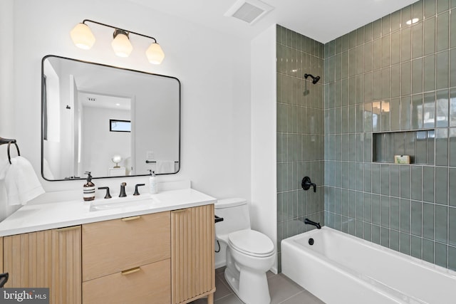 full bathroom featuring toilet, tile patterned flooring, vanity, and tiled shower / bath combo