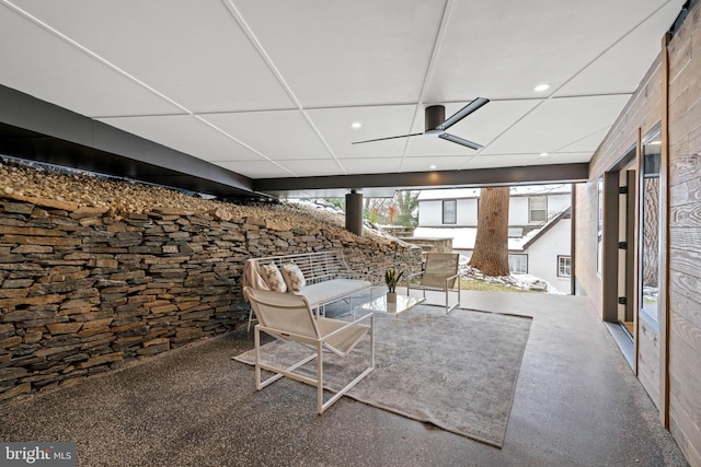 unfurnished living room with ceiling fan and a healthy amount of sunlight