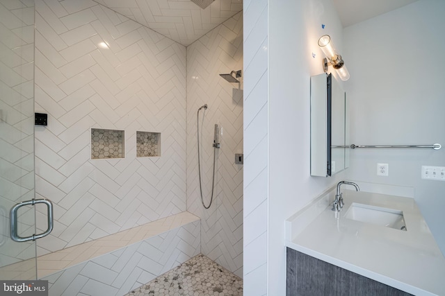 bathroom featuring a stall shower and vanity