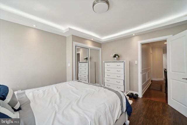 bedroom with wood-type flooring and a closet