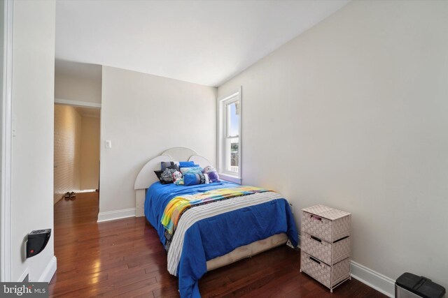 bedroom with dark hardwood / wood-style floors