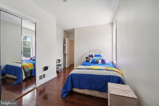 bedroom with dark wood-type flooring