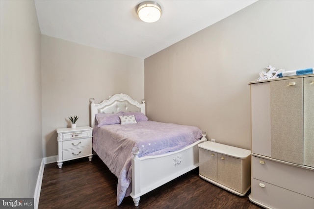 bedroom with dark hardwood / wood-style floors