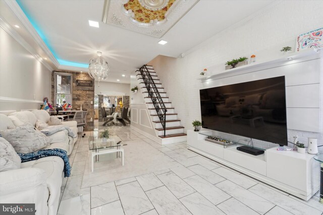 tiled living room featuring ornamental molding and an inviting chandelier