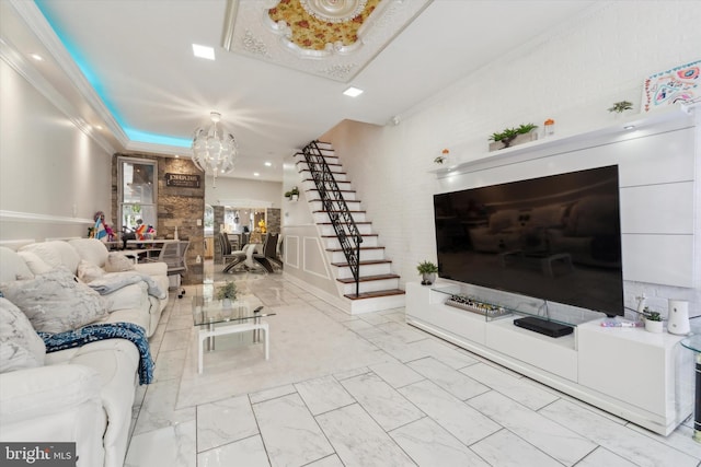 living room with an inviting chandelier and ornamental molding