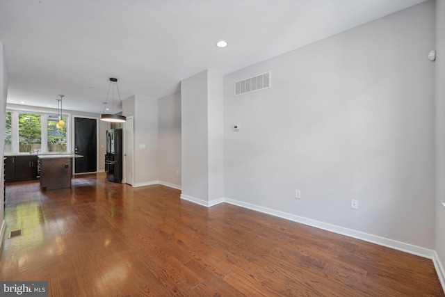 unfurnished living room featuring dark hardwood / wood-style flooring