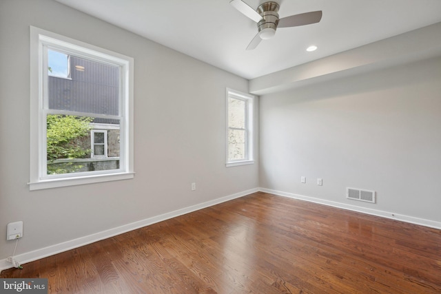 spare room with hardwood / wood-style floors and ceiling fan