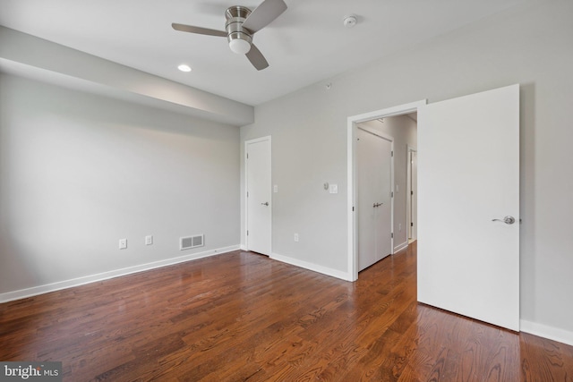 unfurnished bedroom featuring dark hardwood / wood-style floors and ceiling fan