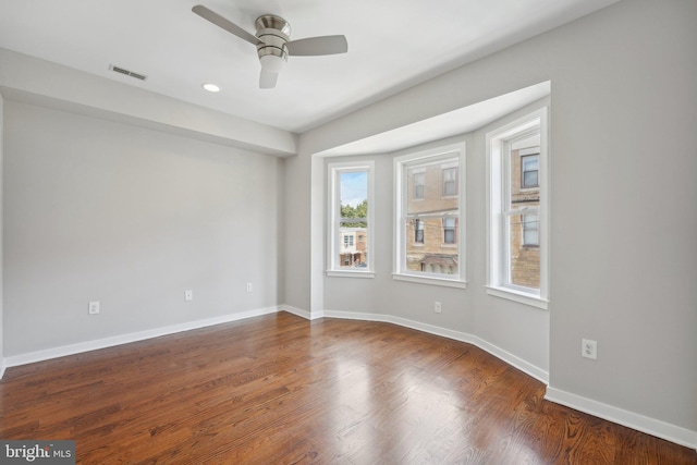 spare room featuring ceiling fan and dark hardwood / wood-style floors