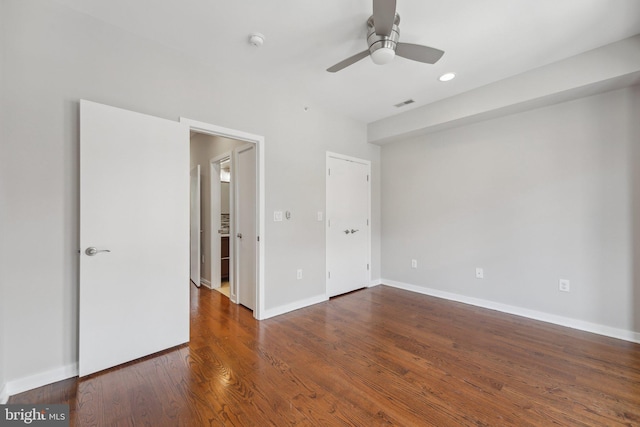 unfurnished bedroom with dark hardwood / wood-style floors and ceiling fan