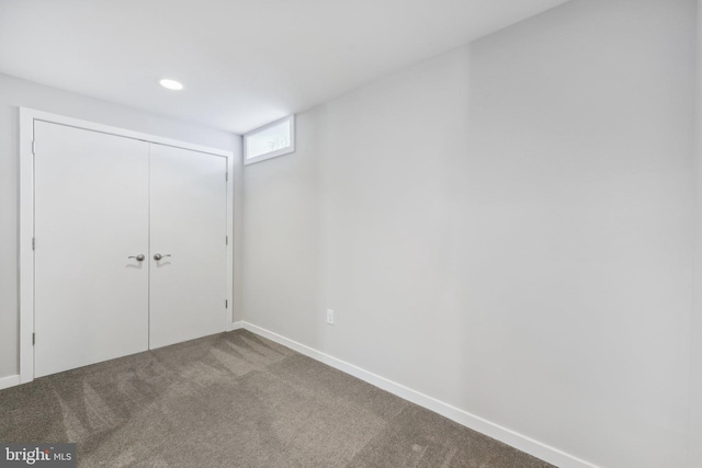 unfurnished bedroom featuring carpet floors and a closet