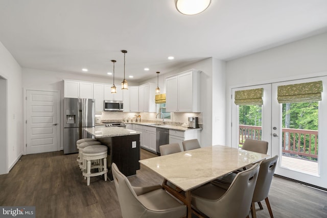 dining space featuring dark hardwood / wood-style floors, sink, and french doors