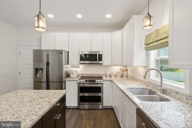 kitchen with stainless steel appliances, decorative backsplash, white cabinetry, dark hardwood / wood-style floors, and sink