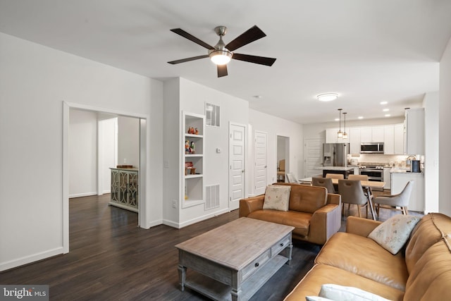 living room with ceiling fan and wood-type flooring