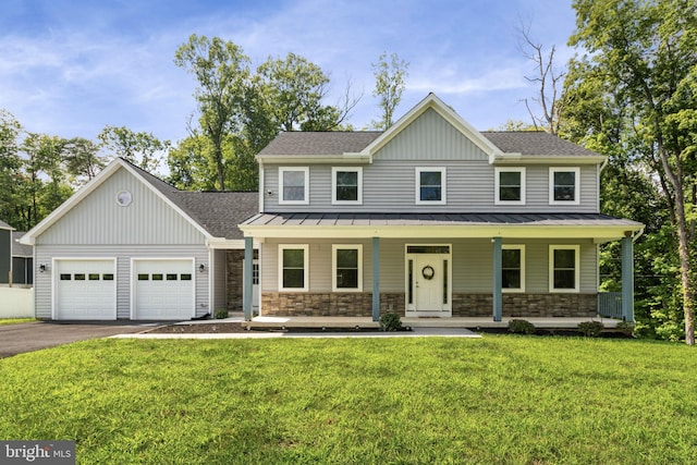 view of front facade featuring a garage, a porch, and a front yard