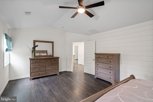 bedroom featuring dark hardwood / wood-style flooring, lofted ceiling, and ceiling fan