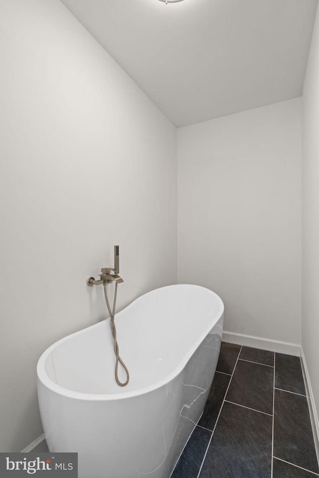 bathroom with a bathing tub and tile patterned floors