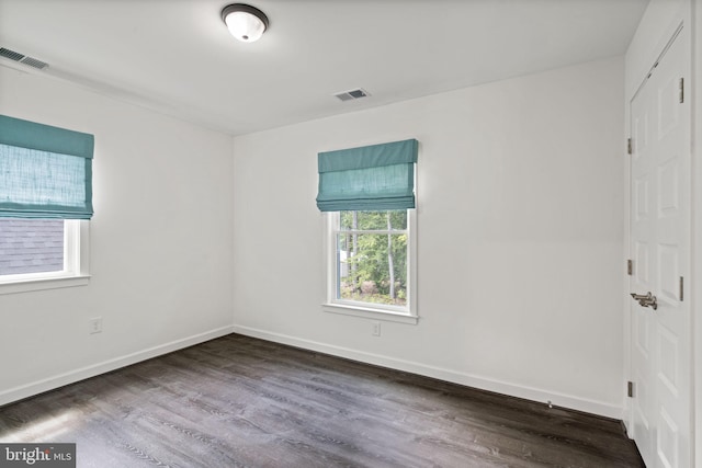 unfurnished room with hardwood / wood-style floors