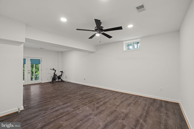 empty room with ceiling fan, french doors, and dark wood-type flooring