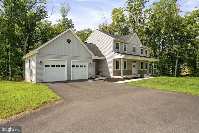 view of front facade with a front lawn, a garage, and a porch