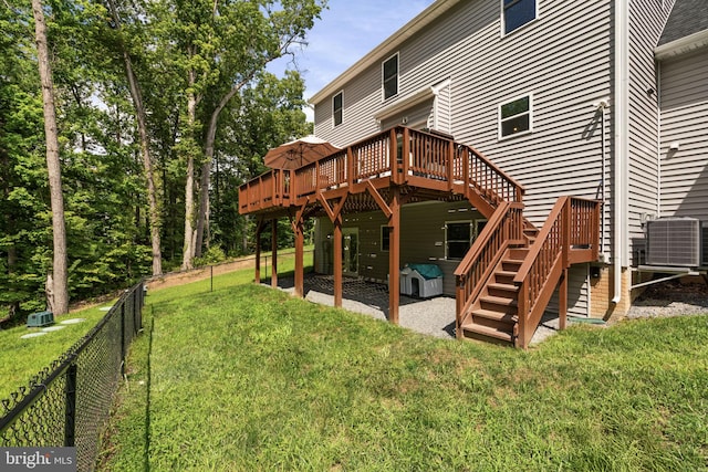 back of property featuring central air condition unit, a deck, a patio area, and a lawn