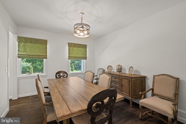 dining space featuring a notable chandelier and dark hardwood / wood-style floors