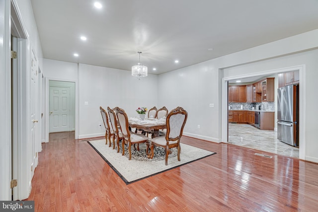 tiled dining area with a chandelier