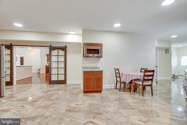 tiled dining area with a barn door