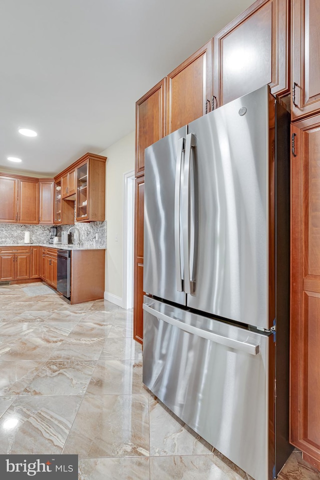 kitchen with sink, decorative backsplash, appliances with stainless steel finishes, and light tile patterned floors