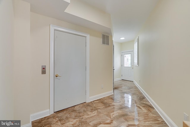 hall featuring light tile patterned flooring