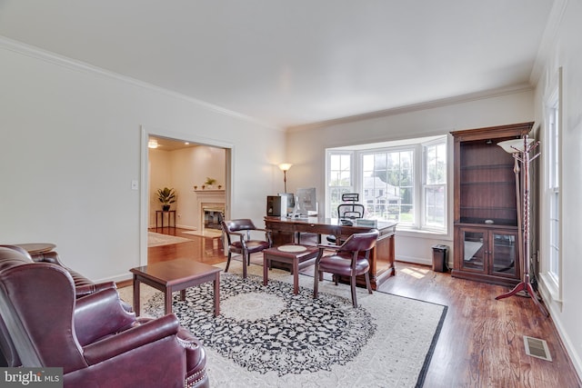 office space featuring light wood-type flooring and ornamental molding