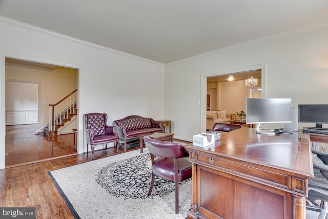 home office featuring hardwood / wood-style flooring, ornamental molding, and a chandelier