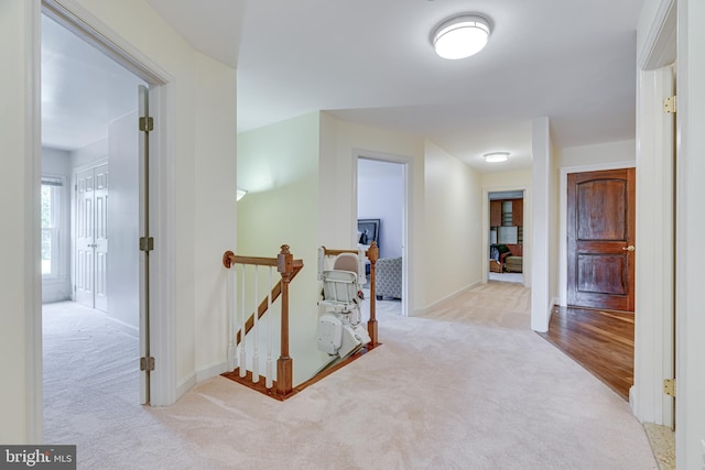 hall featuring light colored carpet