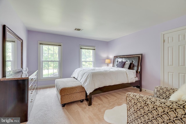 bedroom featuring light carpet