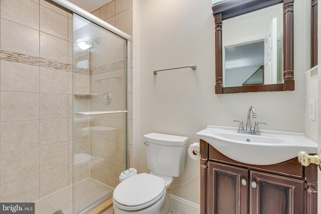 bathroom with vanity, walk in shower, and toilet