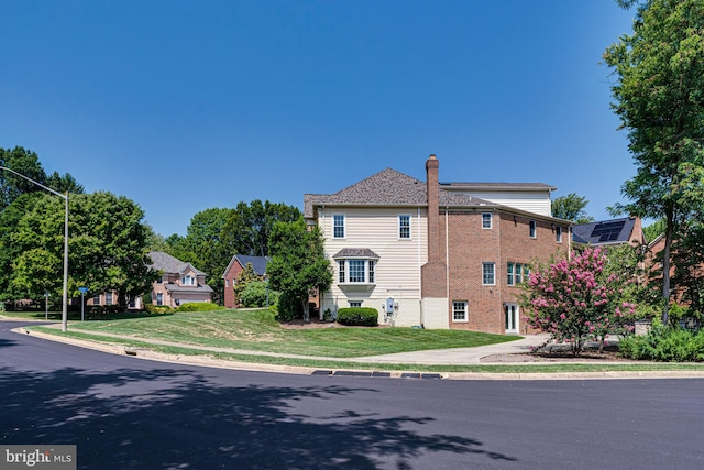 view of property exterior with a lawn