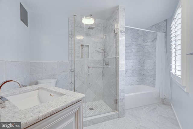 full bathroom with toilet, vanity, tile patterned floors, tile walls, and plus walk in shower