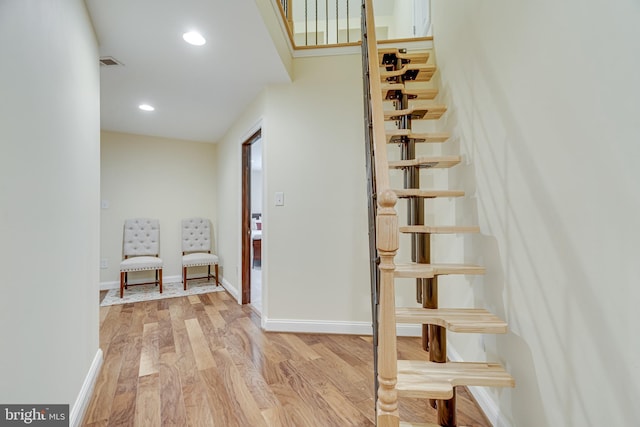 staircase with hardwood / wood-style flooring