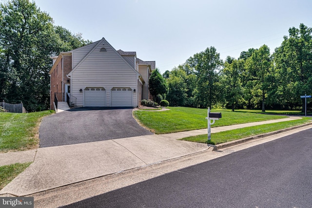 view of front of home with a garage and a front lawn