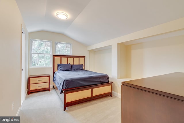 carpeted bedroom featuring lofted ceiling