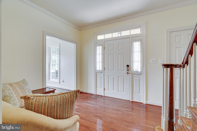 foyer with crown molding and wood-type flooring