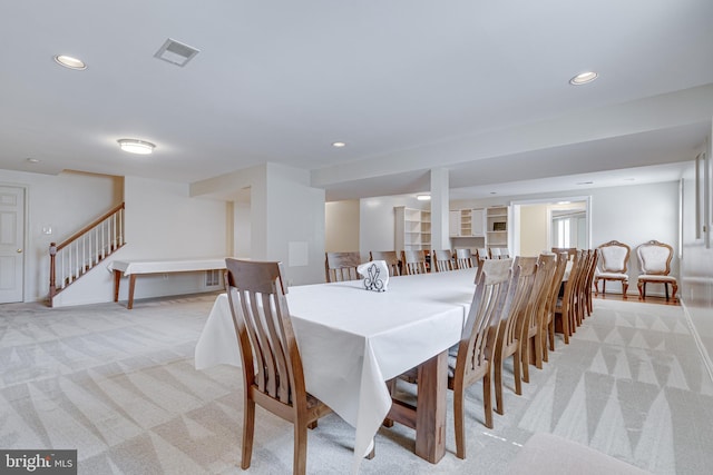 dining space featuring light colored carpet