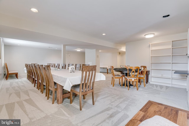 dining room featuring light carpet