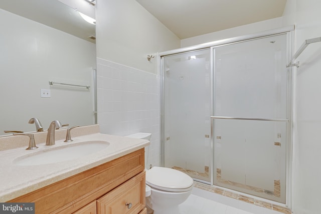 bathroom featuring toilet, vanity, walk in shower, and tile patterned floors