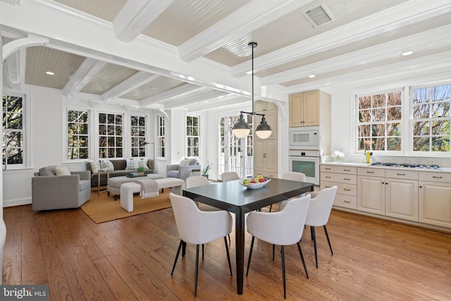 dining area featuring recessed lighting, visible vents, beam ceiling, light wood finished floors, and crown molding