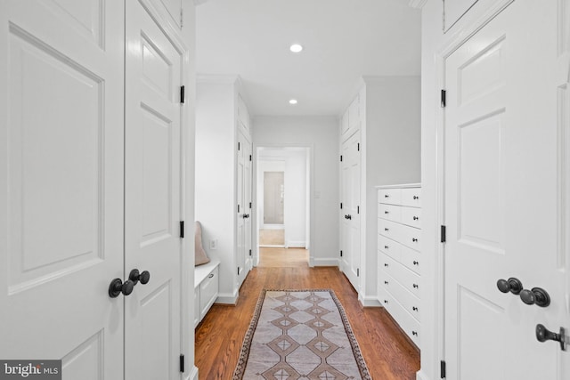 corridor with recessed lighting, baseboards, and wood finished floors