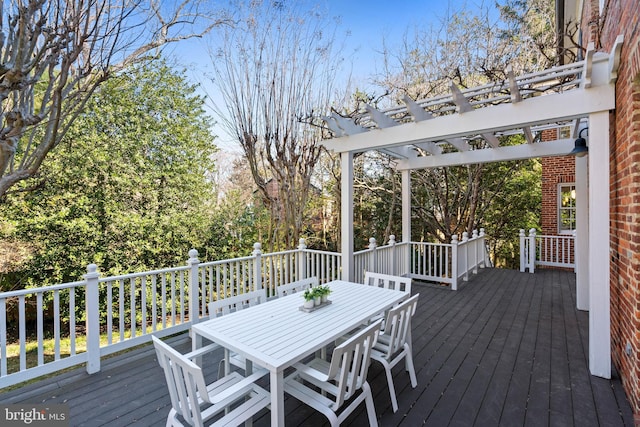 wooden terrace featuring outdoor dining area and a pergola