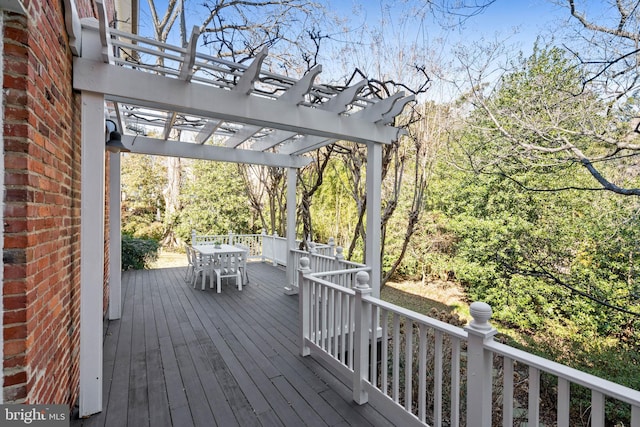 wooden deck featuring a pergola and outdoor dining space